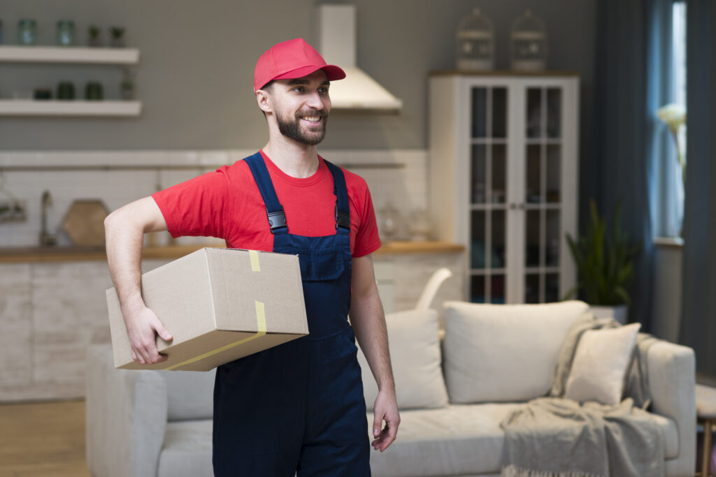 front view smiley delivery man holding boxes